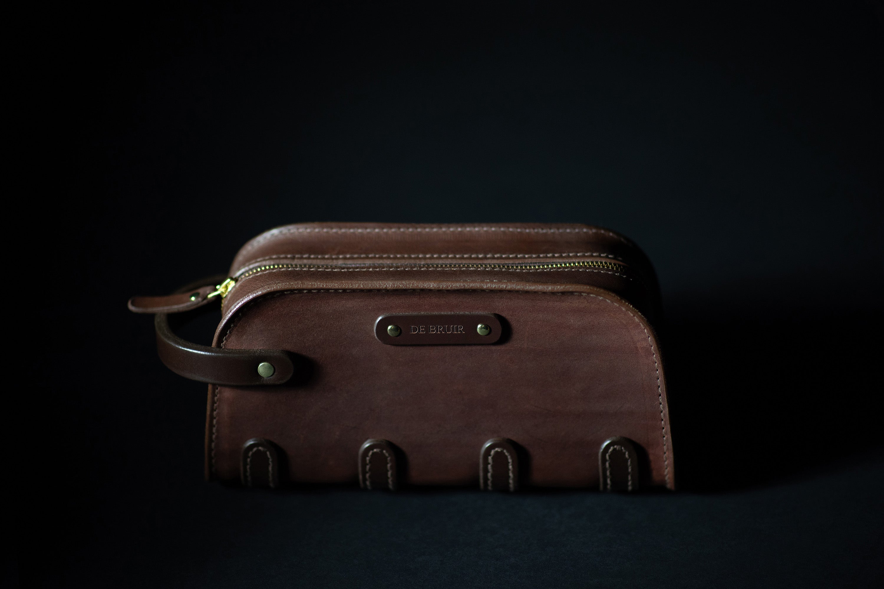 Leather washbag closed zip with dark background